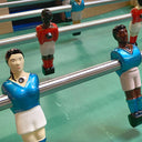 Close-up of foosball figures on a table with a focus on detail